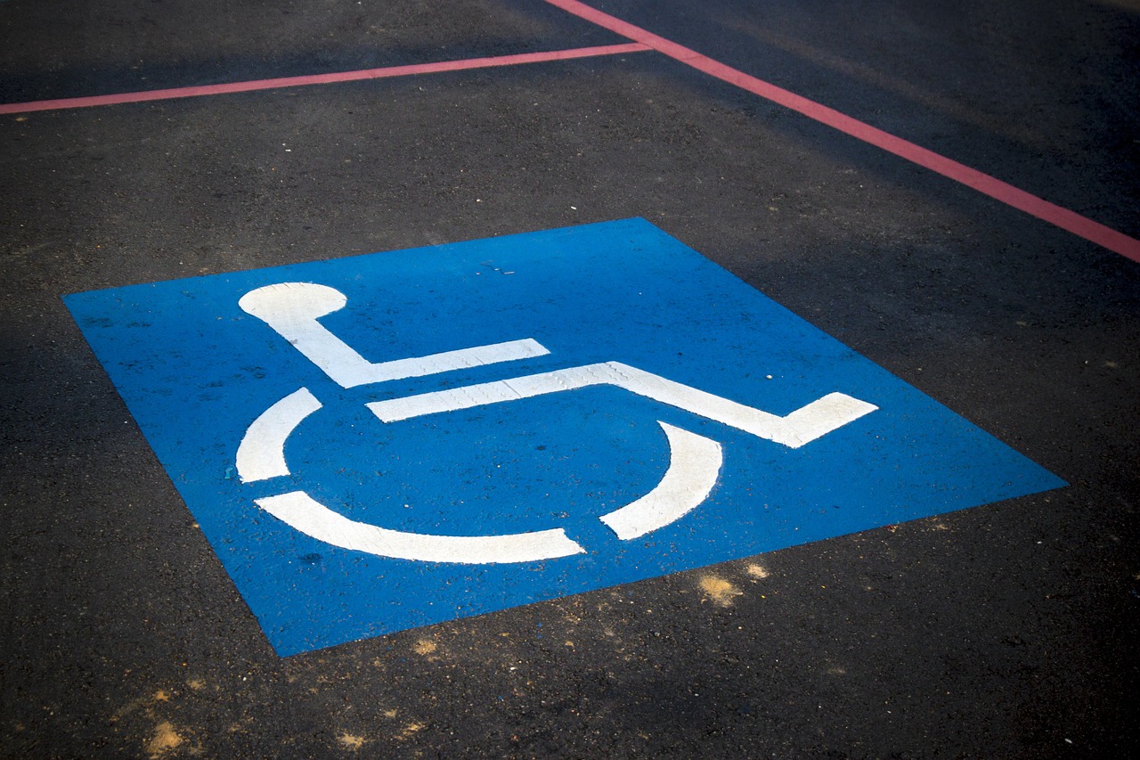 A handicap parking decal in a parking lot