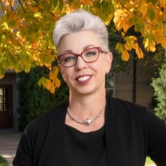 Flower Darby headshot with a fall motif in the background