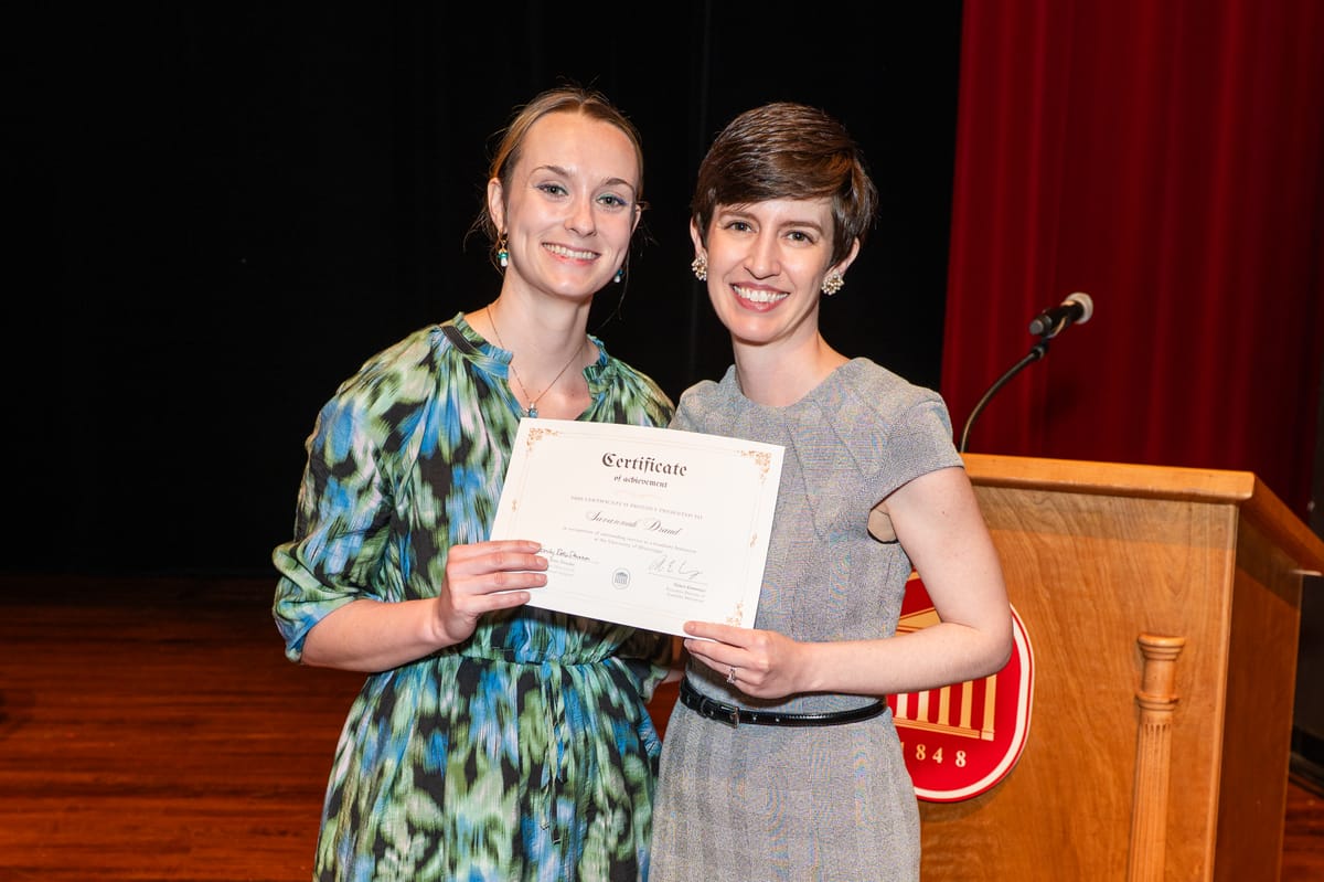 Savannah Draud and Dr. Emily Pitts Donahoe hold Draud's certificate awarded at the 2025 Celebration of Doctoral Achievement.
